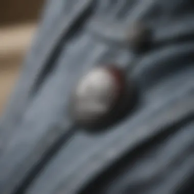 Close-up of the button detailing on Adidas pants