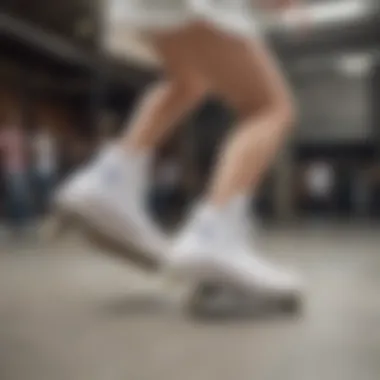 Female skater performing a trick while wearing all-white Converse