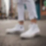 All-white Converse sneakers against a vibrant urban backdrop