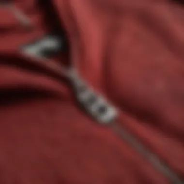 Close-up of the fabric texture of a dark red zip-up hoodie.