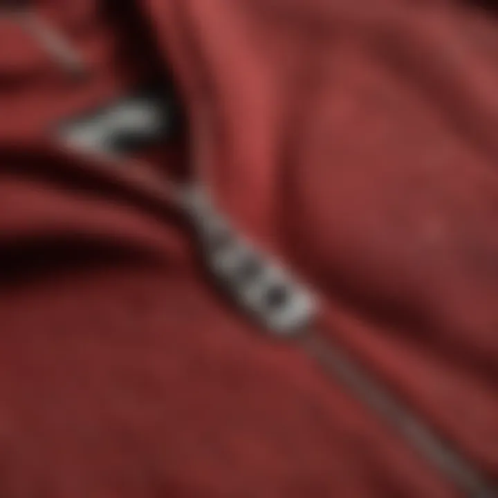 Close-up of the fabric texture of a dark red zip-up hoodie.