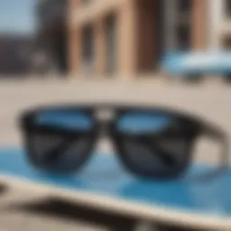 A close-up of black sunglasses with a skateboard in the background.