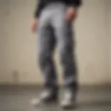 Close-up of a skateboarder wearing grey Dickies pants, showcasing style and functionality.