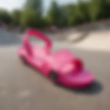 Vibrant hot pink Kappa slides showcased against a skate park backdrop