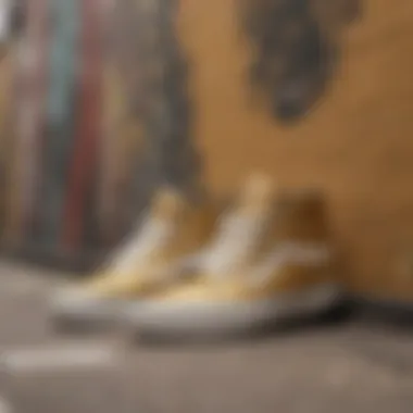 Artistic display of metallic gold Vans on a graffiti wall background