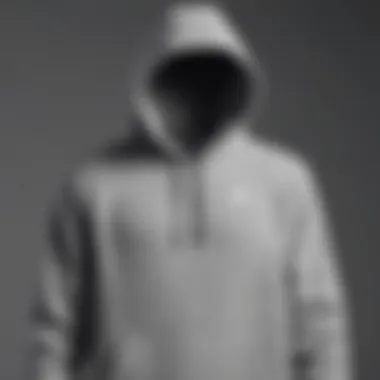 Nike grey pullover hoodie displayed against a minimalist backdrop