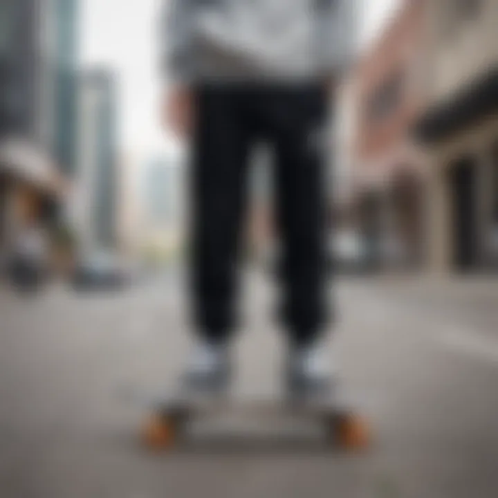 A stylish pair of cute black sweatpants displayed on a skateboard