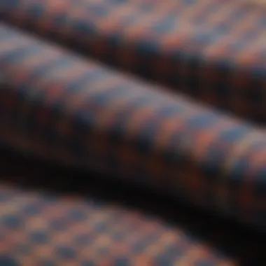 A close-up view of fabric textures and patterns of flannel shirts, highlighting quality and design.