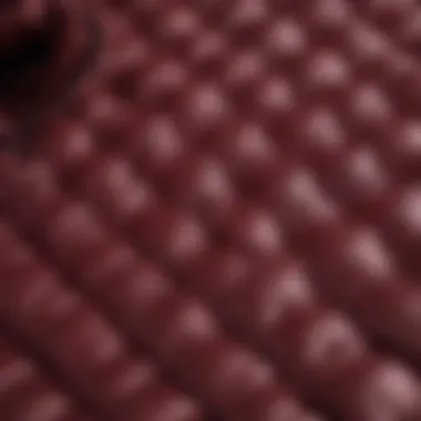 Close-up of burgundy fabric texture and stitching