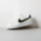 Stylish white Nike shoes with black Swoosh against a minimalist background